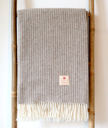 Elegante Tagesdecke aus 90% Merinowolle und 10% Kaschmir von Interior by Hakito, weich mit dezenten Streifen und Fransen, perfekt für jedes Zuhause.