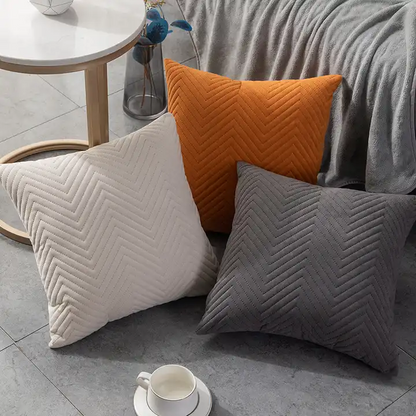 Modisches Kissen Rolf 2er Set von Interior by Hakito, zeigt eine Vielzahl von Farben, darunter Orange und Grau, ideal für einladende Wohnräume und vielseitig einsetzbar.